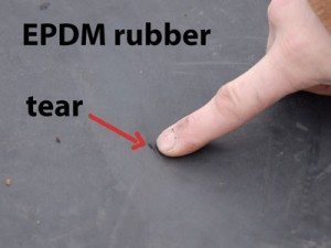 Flat roof EPDM rubber with tear that leads to leaking. Rubber Roof Repair - Tear in EPDM Rubber - Missouri