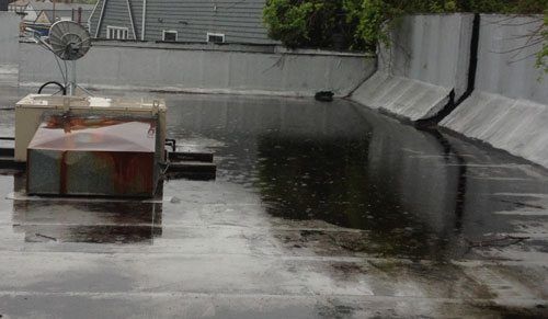 Ponding water due to a blocked drain. The water pooling is adding a lot of stress to the flat roof.