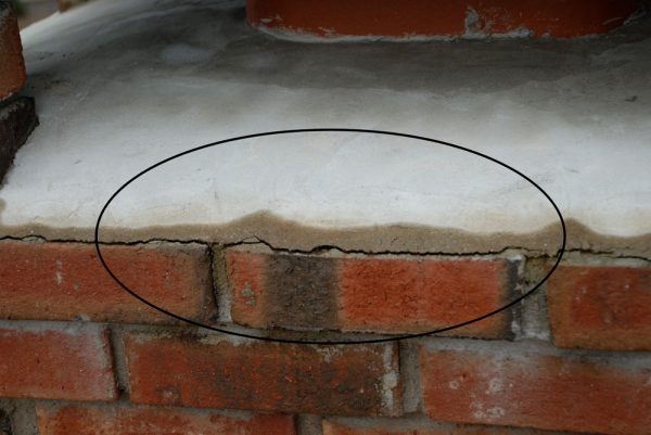 The cement slab on top of the chimney has cracked away and need to be sealed with Turbo poly Seal by Bergstromm.com