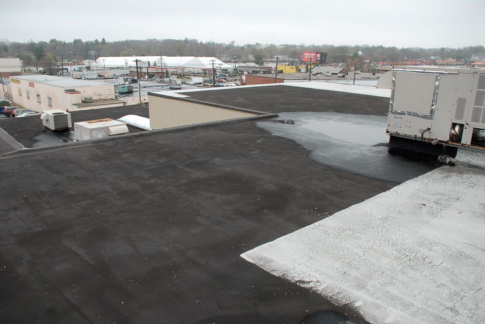 Partially coated asphalt roof - They did not do it to protect the roof but rather to seal against a leak