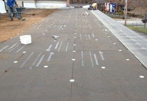 Rubber roof installation on a commercial roof. Fiberboard is installed first, then a base sheet, then the final cap sheet. Ohio