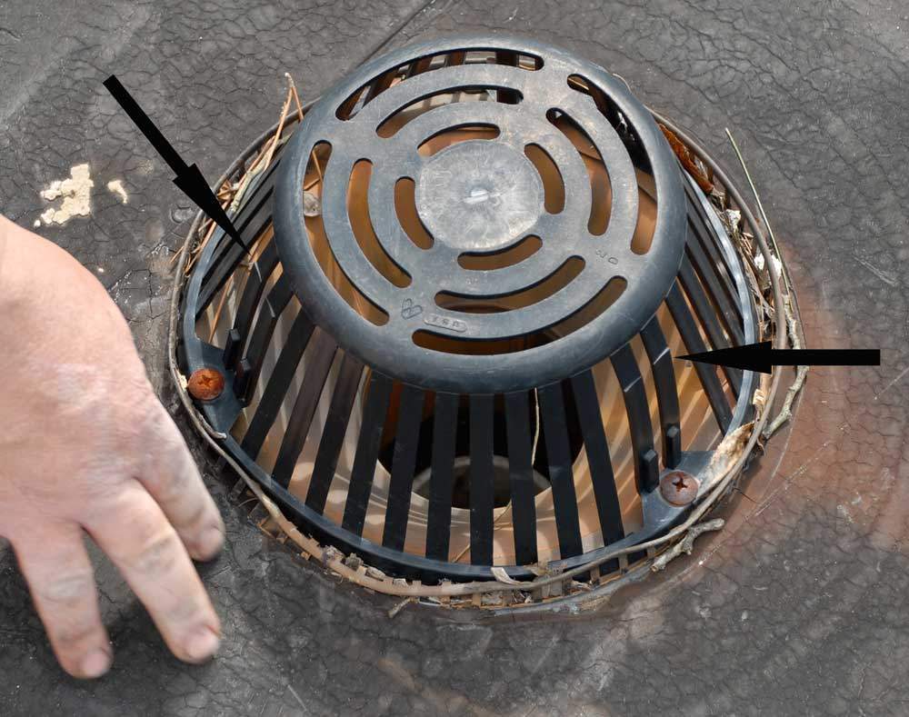 Flat Roof Drains and Strainers - Notice the cracks on this plastic strainer. Eventually, the strainer will develop more cracks, then break apart, and become ineffective.