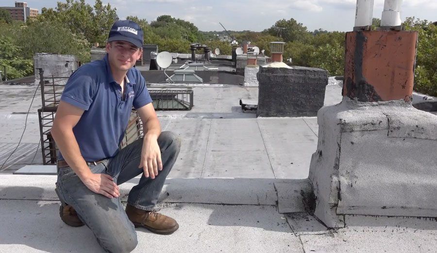 Brownstone Roofs in Brooklyn - Both the chimney and parapet walls were smeared with tar. We not only recovered the roof, but we also covered the parapet walls and chimney with the Modified Bitumen Torch Down rubber