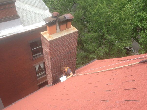 Rappelling to repair flashing on a chimney in Brooklyn, NY.