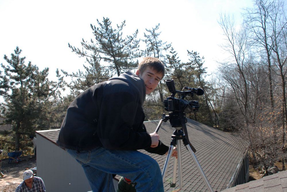 Erik behind the camera for videos on a roof