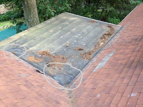 This EPDM Rubber roof shows that a repair was needed due to repeated foot traffic used to access the sloped roof.