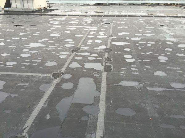 EPDM Membrane roof - Defective Adhesives - Patches on a EPDM rubber roof indicates a premature failure of a roofing system.