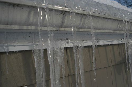 Gutters and Flat Roofs - Important Drainage System - Gutters with built up of ice and icicles often break. 