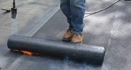 Torching down roofing or heat fusing a Modified Bitumen Rubber Membrane