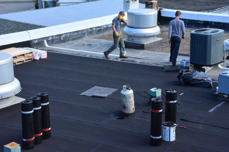 Installing a Two Ply Torch Down rubber roof over Tar and Gravel