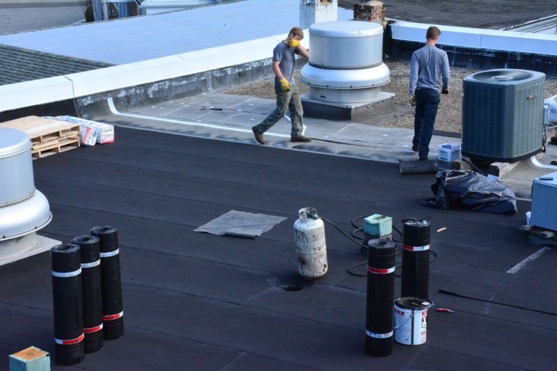  Installing a Two Ply Torch Down rubber roof over Tar and Gravel