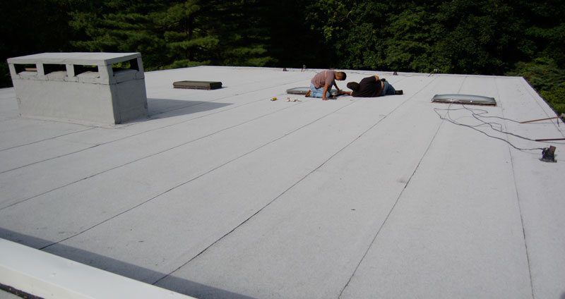 Commercial Flat Roof - The image is an example of a 2 Ply Modified Bitumen Torch Down Rubber Roof System.