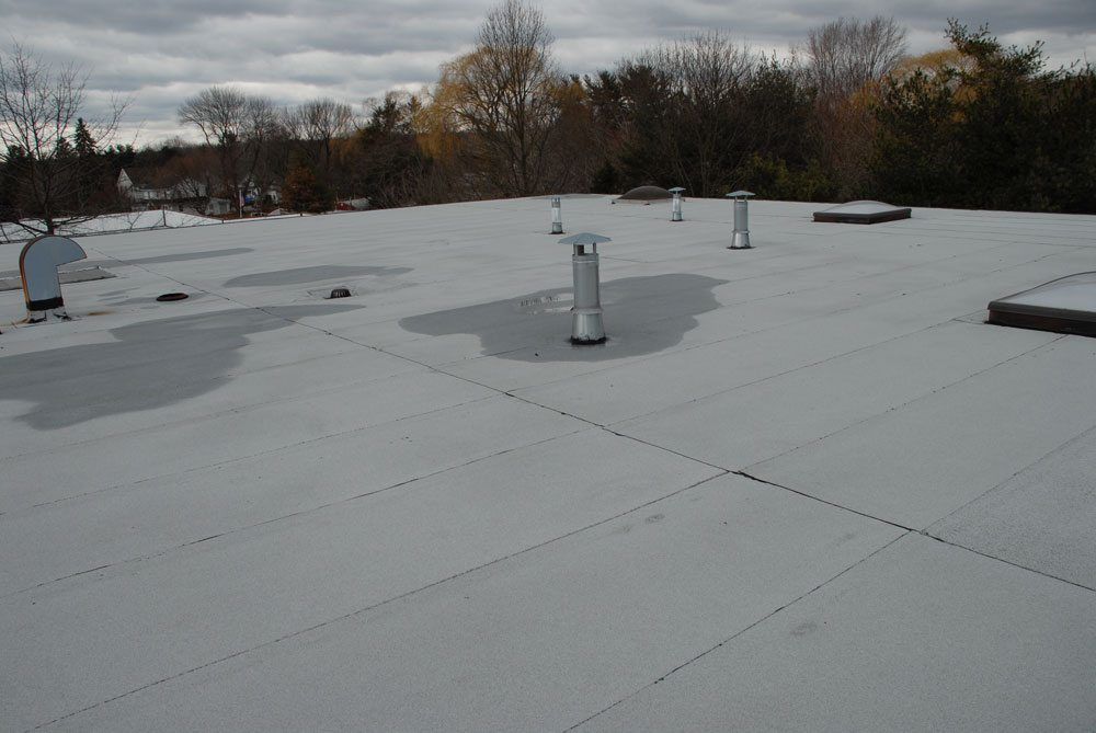 EPDM Rubber and Torch Down Rubber - After 14 years, a Torch Down Rubber Roof shows no maintenance in terms of repairs. 