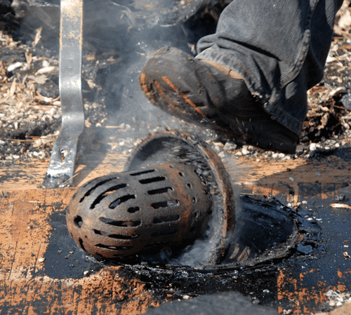 Commercial flat roof drain installation - This is an old cast iron drain and strainer. The strainer's holes and slots are too small, which caused small debris to build up and block water flow.