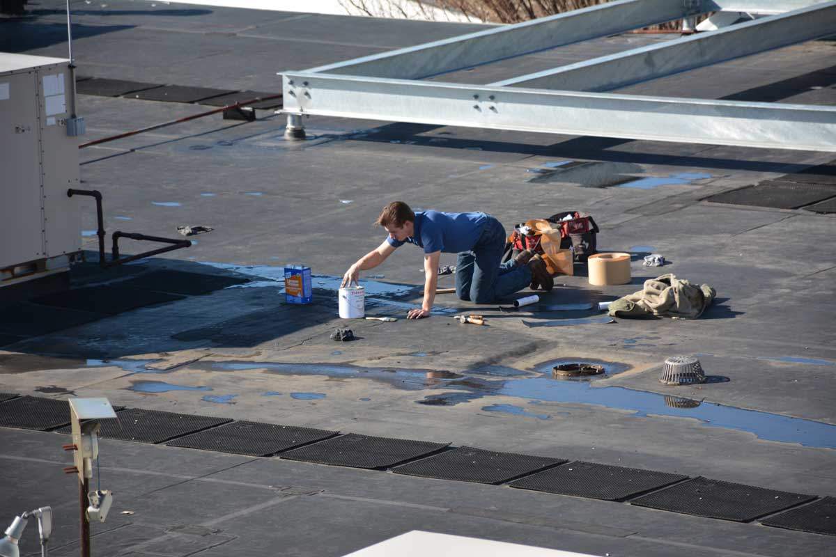 EPDM Rubber Membrane Roof being patched - flat roof materials