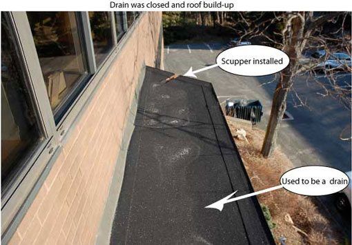 Flat roof repair - The drain was eliminated and scuppers were installed that drained into the planter.