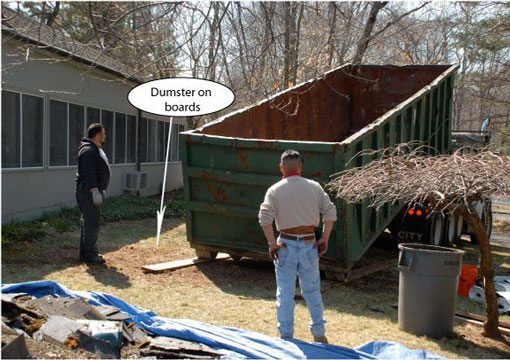Step 8 - Dumpster - having it close to the roof. Make sure you get a big enough dumpster to remove all the roofing debris. Always put boards down for the dumpster to stand on to protect the surface.