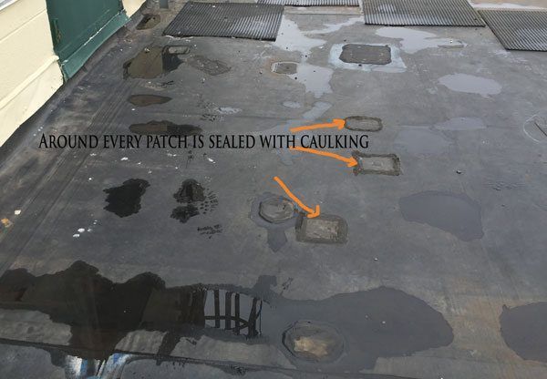 signs of repairs on a EPDM Rubber roof are all the patches - this becomes costly and not worth repairing