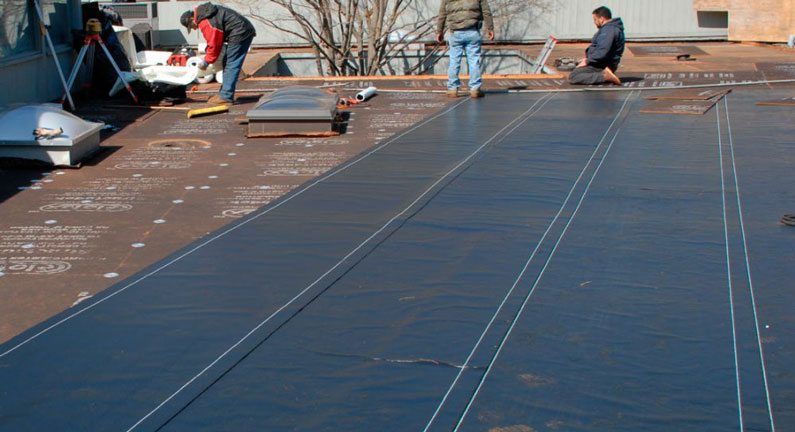 commercial residential rubber roofs- This is the installation of the First layer before Torching the final layer on top