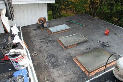 Skylight Repair - After cleaning the flashing on a skylight, it is time to install new flashing membrane over the copper flashing.